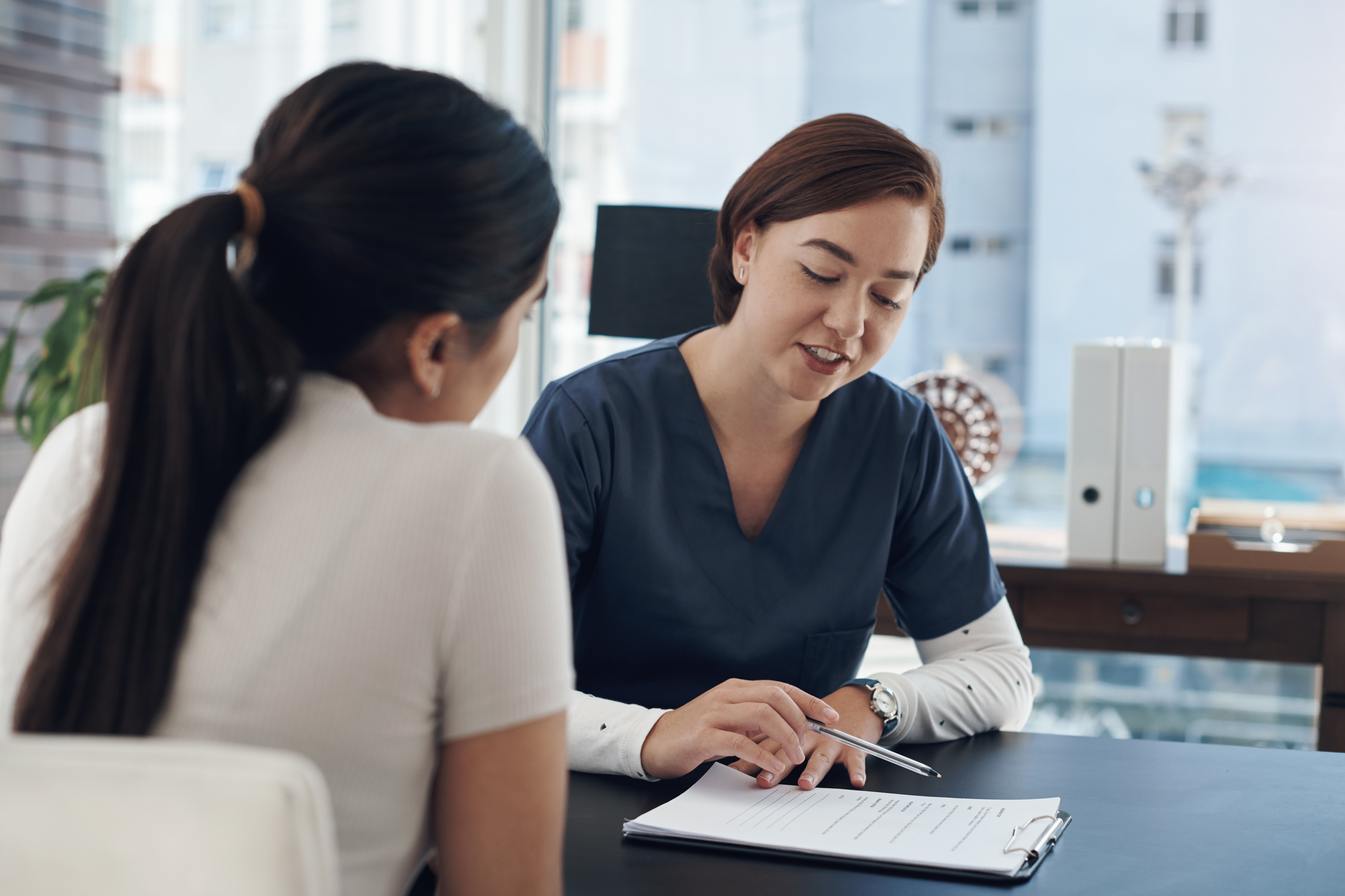 nurse speaking with young woman